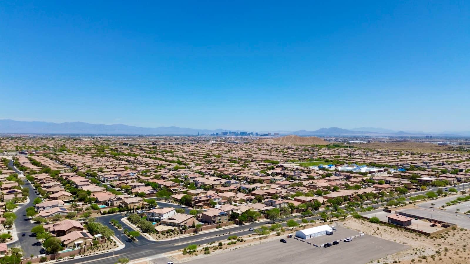 Aerial view of a Las Vegas valley neighborhood with the Strip skyline on the horizon